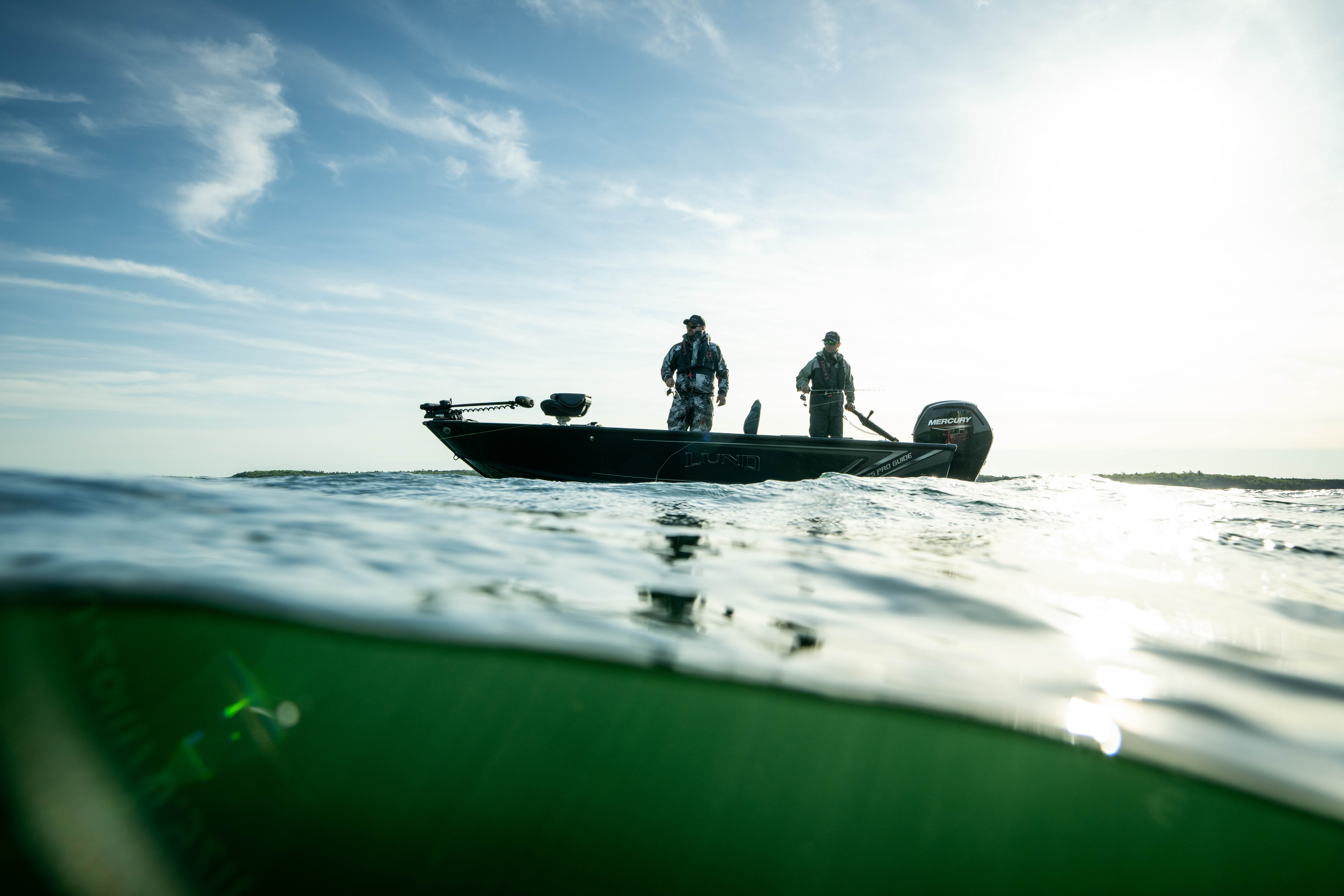 two anglers on a boat in the middle of a lake